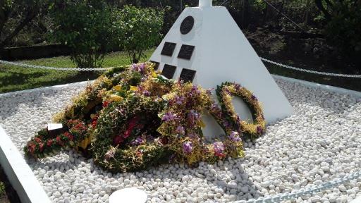The Memorial at Rove Memorial Garden surrounded by wreaths (Photo OAG)